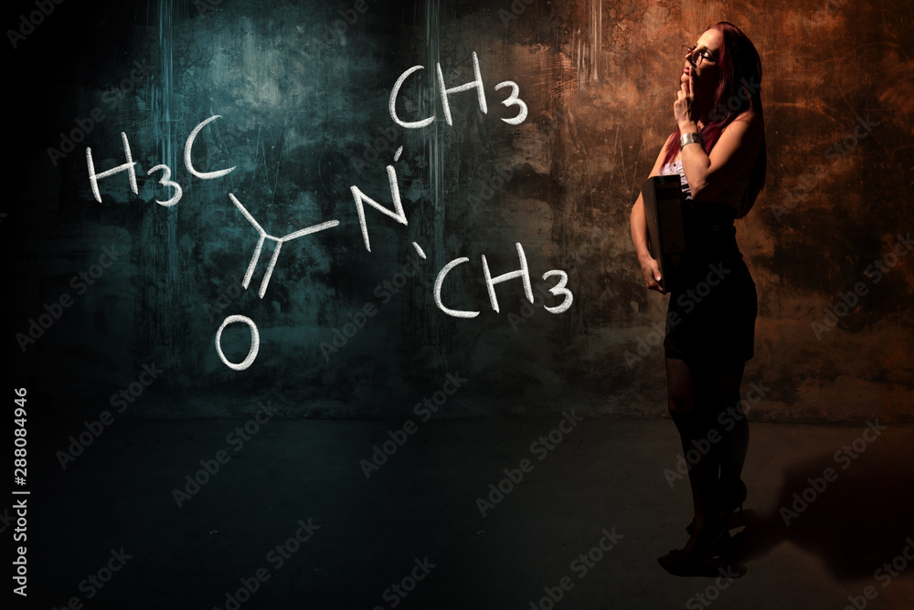Sexy girl or secretary or female student presenting handdrawn chemical formula of Dimethylacetamide Sexy girl or secretary or female student presenting handdrawn chemical formula of Dimethylacetamide