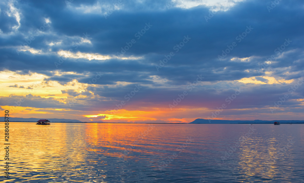 Aerial view, Beautiful Orange and red dramatic colors of sunset and cirrus clouds above the sea. Sky blue and orange natural dawn composition over the sea, Warm colors reflect the water surface.