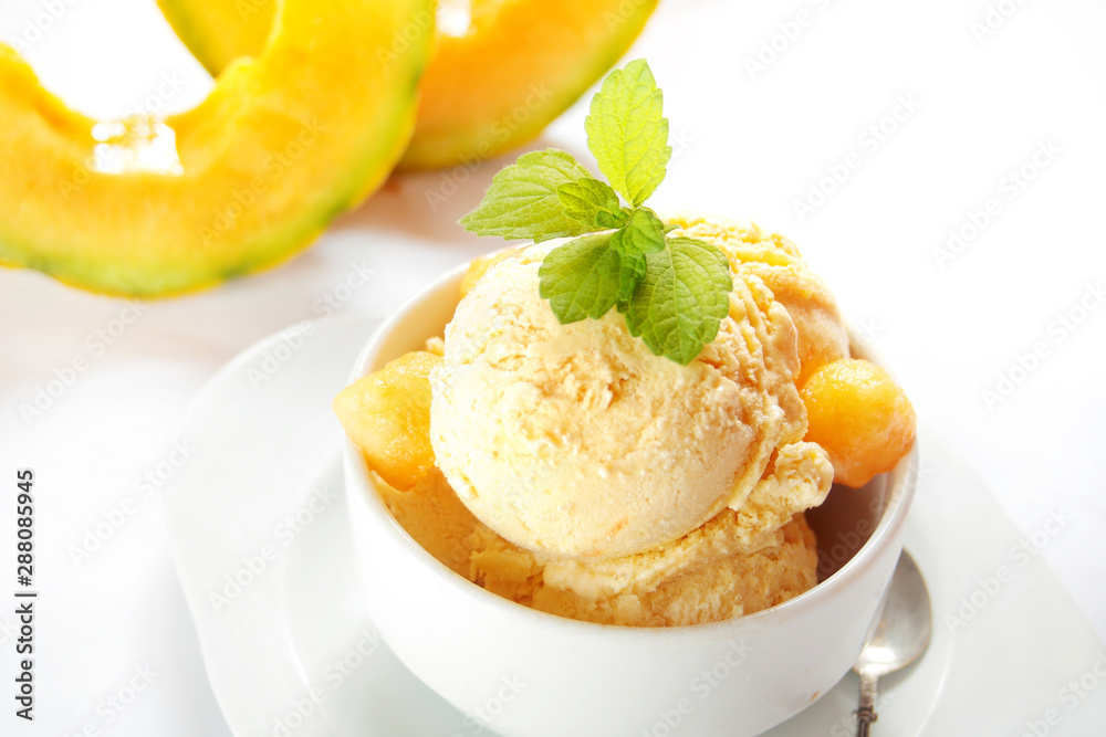 Fresh melon ice cream with melon and melissa on white background Fresh melon ice cream with melon and melissa on white background