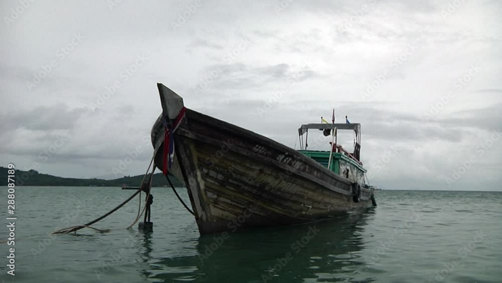 Old Wooden Boat anchored down in Phuket Old Wooden Boat anchored down in Phuket