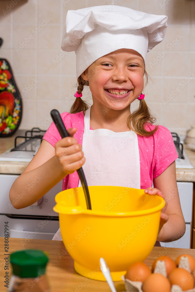 Little girl in a cook hat close up Little girl in a cook hat close up