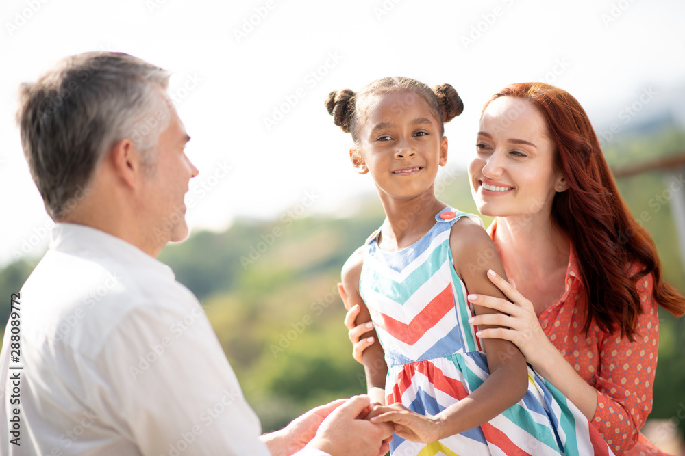 Beautiful red-haired woman hugging her foster daughter Beautiful red-haired woman hugging her foster daughter
