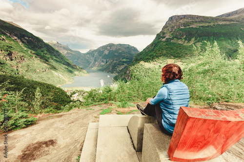 Tourist enjoying Geirangerfjord from viewing point photo
