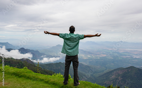man Isolated soaking natural beauty from hill top
