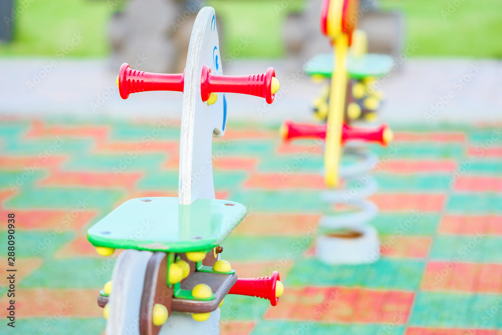 The image of a swing in a kindergatten The image of a swing in a kindergatten