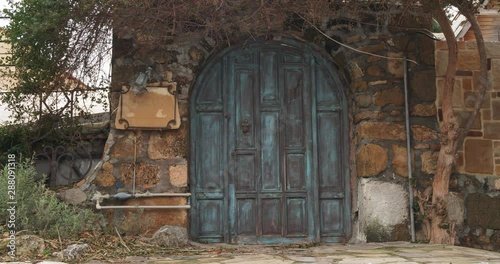 Beautiful old wooden gate build in stone wall