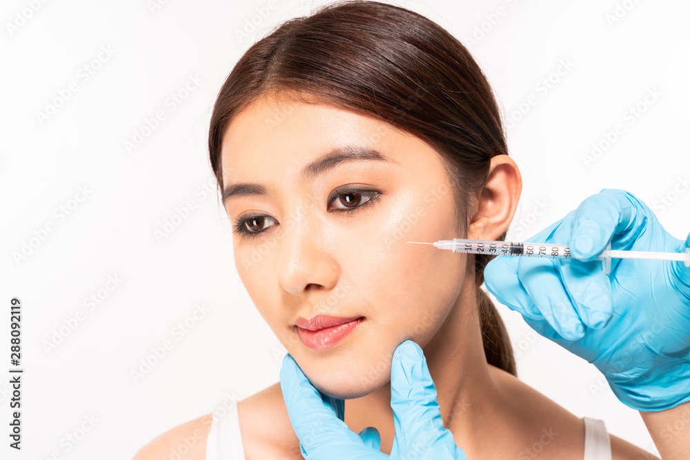 Close up woman getting cosmetic injection of botox in cheek Close up woman getting cosmetic injection of botox in cheek