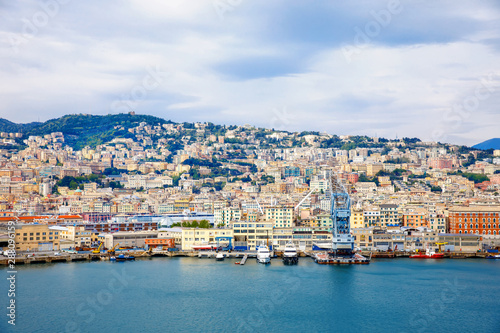 View of Genoa Genova city and port harbor with sea view and yachts, ships. Liguria region of Italy. On cloudy day from high angle