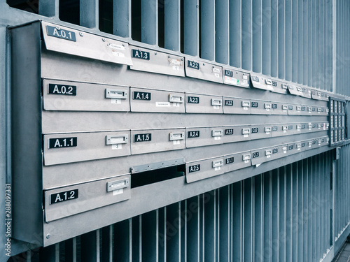 Rows of gray post boxes on the street in Brussels. Color toned.