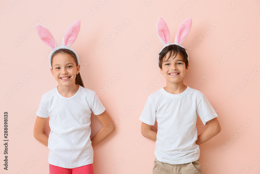 Happy little children wearing bunny ears on color background - obrazy, fototapety, plakaty 
