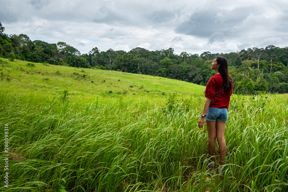 Beautiful young woman enjoying sun and fresh air in a field,happy day