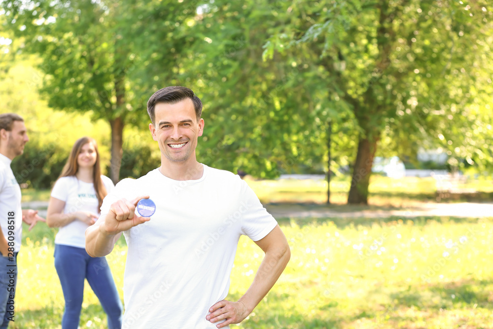 Portrait of male volunteer with badge outdoors Portrait of male volunteer with badge outdoors