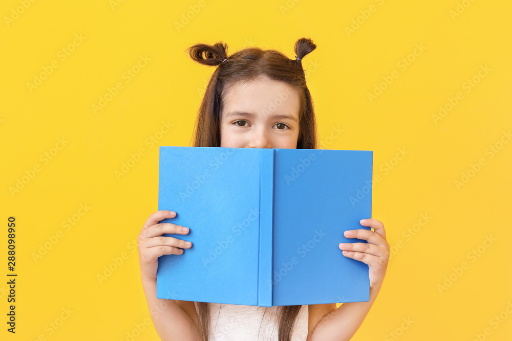 Cute little girl with book on color background Cute little girl with book on color background