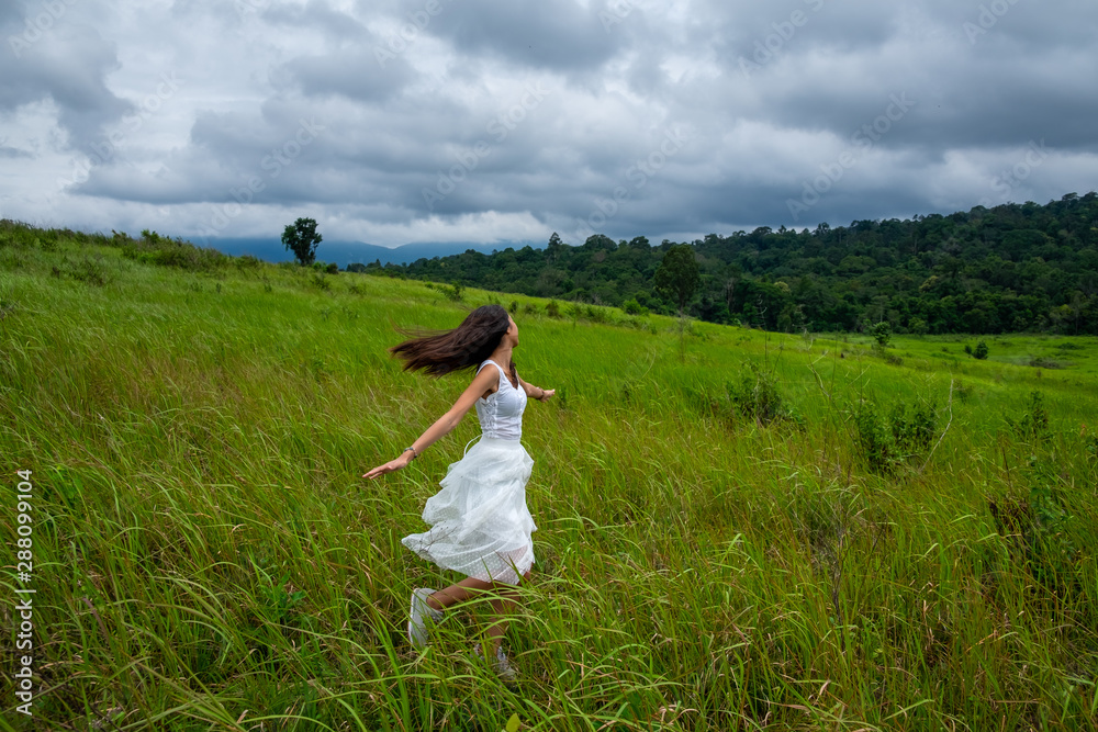Beautiful young woman enjoying sun and fresh air in a field,happy day Beautiful young woman enjoying sun and fresh air in a field,happy day