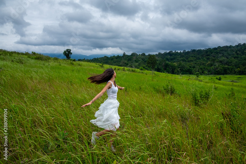 Beautiful young woman enjoying sun and fresh air in a field,happy day
