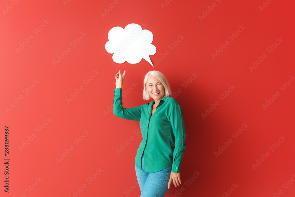 Mature woman with blank speech bubble on color background Mature woman with blank speech bubble on color background