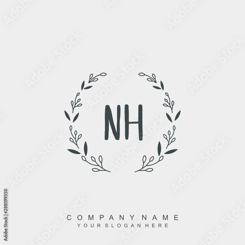 letter NH surrounded by beautiful and elegant flowers and leaves. Wedding monogram logo template.