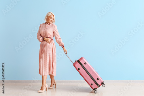 Mature woman with luggage a...