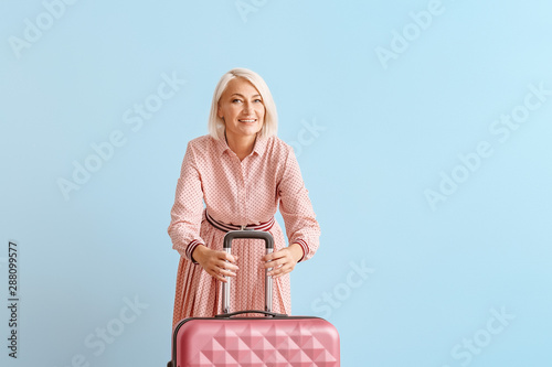 Mature woman with suitcase ...