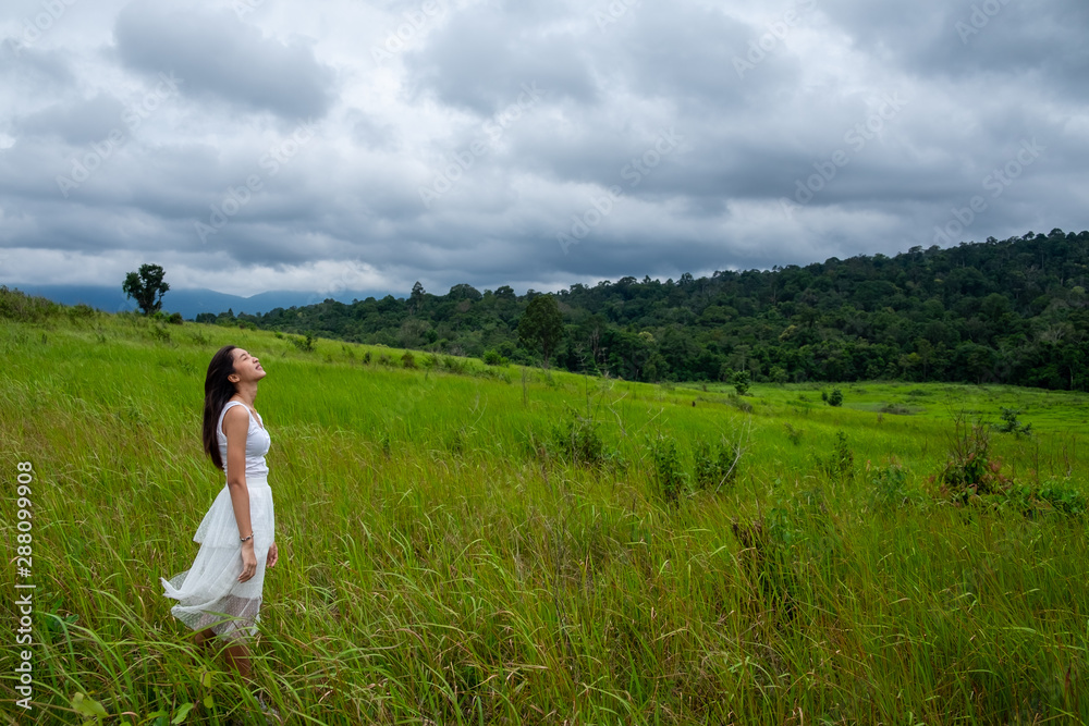 Beautiful young woman enjoying sun and fresh air in a field,happy day Beautiful young woman enjoying sun and fresh air in a field,happy day