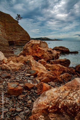 Orange cliffs, and stones in Moon bay, Strunjan. © slunicko24