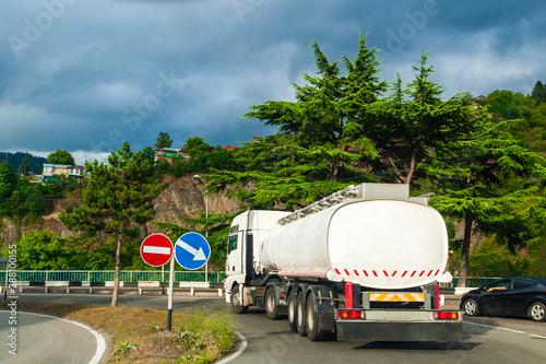 Fuel truck rides on a narrow road, drives into a turn