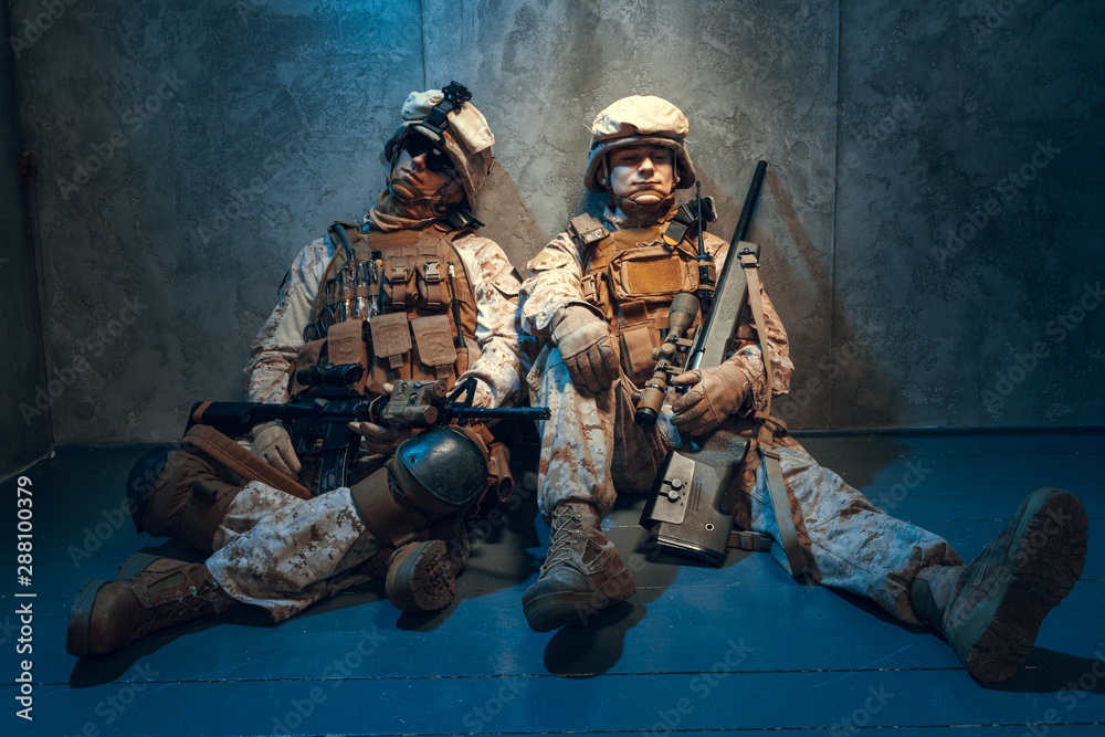 Fototapeta premium Two well equipped US army commandos armed with assault rifles. Studio shot