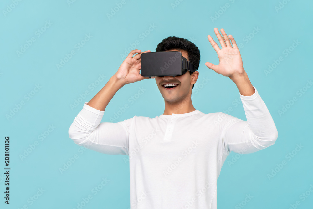 Excited man enjoying watching video from VR glasses Excited man enjoying watching video from VR glasses