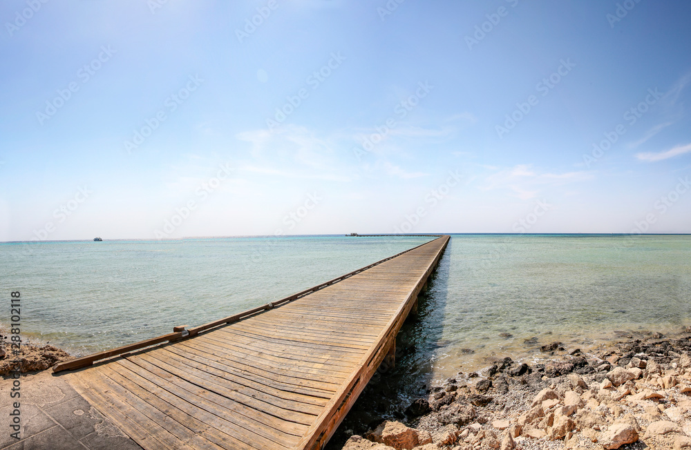 Summer wooden pier and ocean landscape 