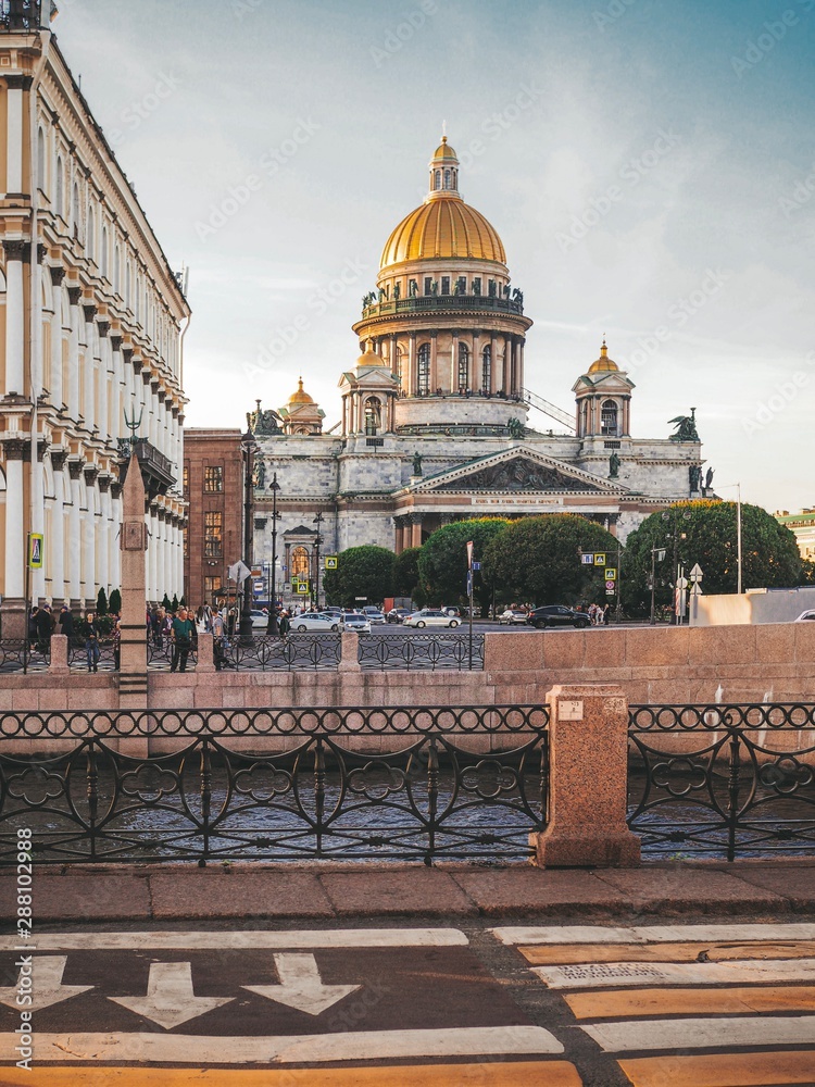 St. Isaac's Cathedral removed from the road in the late afternoon rays of the summer in St. Petersburg
