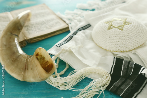 religion image of Prayer Shawl - Tallit, Prayer book and Shofar (horn) jewish religious symbols. Rosh hashanah (jewish New Year holiday), Shabbat and Yom kippur concept. photo