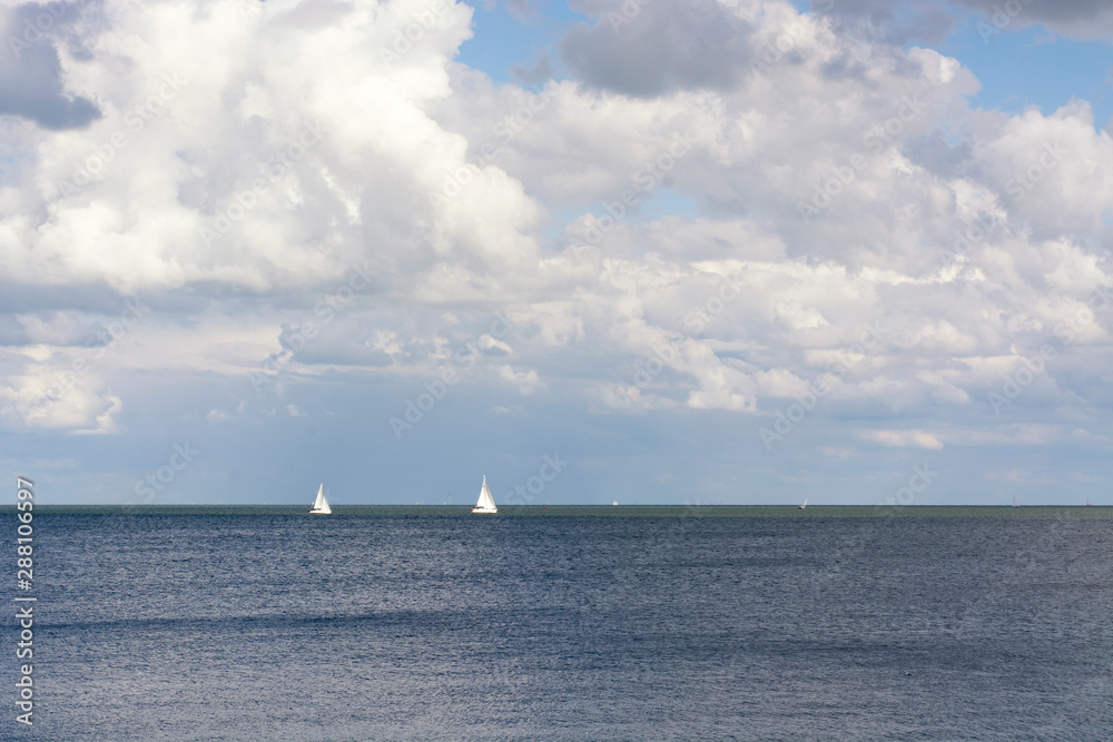 View on two sailingboats on the Gouwzee, near Volendam and the IJsselmeer in the Netherlands. A perfect summer day with typical dutch weater with clouds, sun and blue sky. View on two sailingboats on the Gouwzee, near Volendam and the IJsselmeer in the Netherlands. A perfect summer day with typical dutch weater with clouds, sun and blue sky.