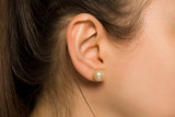 female ear with pearl earring