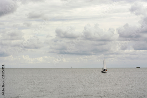 View on two sailingboats on the Gouwzee, near Volendam and the IJsselmeer in the Netherlands. A perfect summer day with typical dutch weather with clouds, sun and blue sky. photo