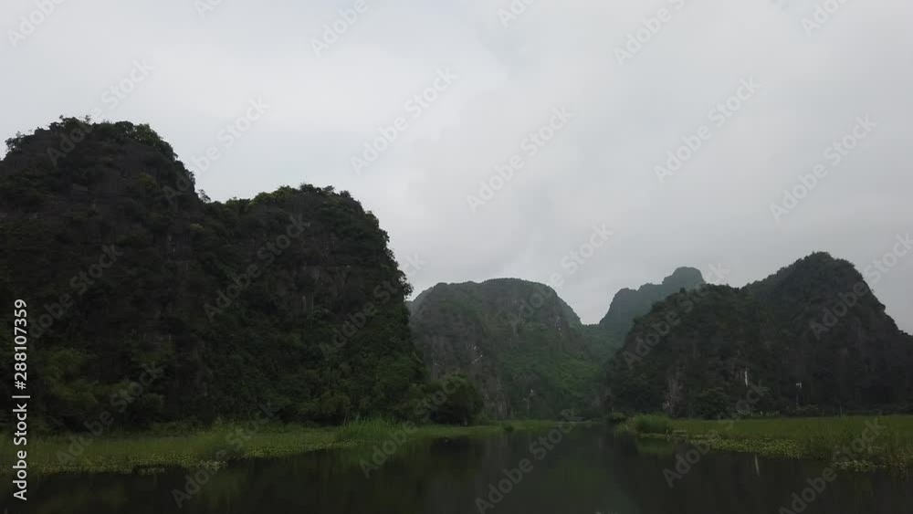 From Sky to the river, adventure day by rowing boat in Tam Coc fantastic limestone landscape and famous UNESCO World Heritage site in north Vietnam who attracts lot of tourists From Sky to the river, adventure day by rowing boat in Tam Coc fantastic limestone landscape and famous UNESCO World Heritage site in north Vietnam who attracts lot of tourists