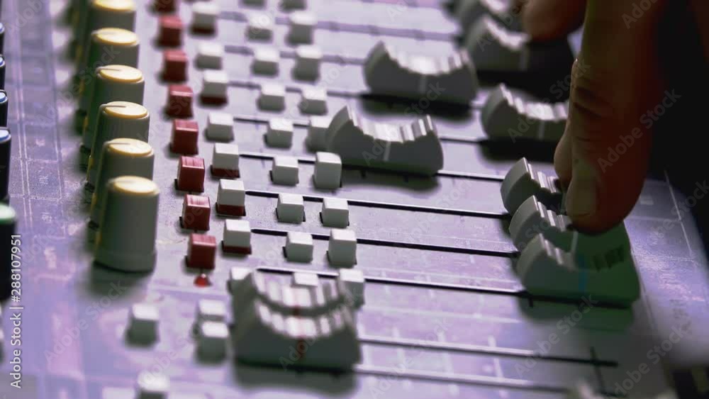 Audio mixing console adjusted by sound technician Audio mixing console adjusted by sound technician
