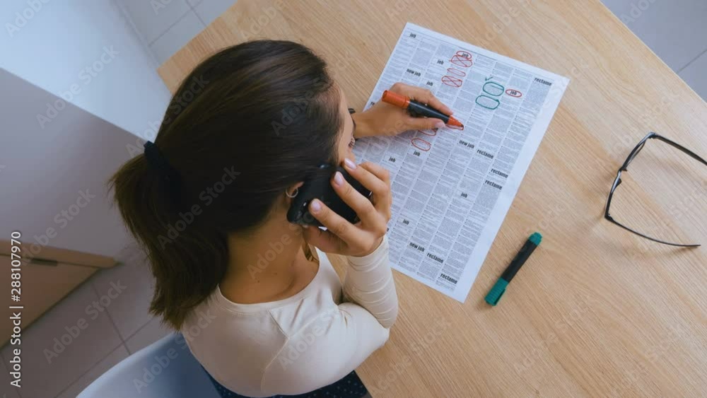 Woman reading newspaper and searching advertisements for employment, job, real estate. 4k Woman reading newspaper and searching advertisements for employment, job, real estate. 4k