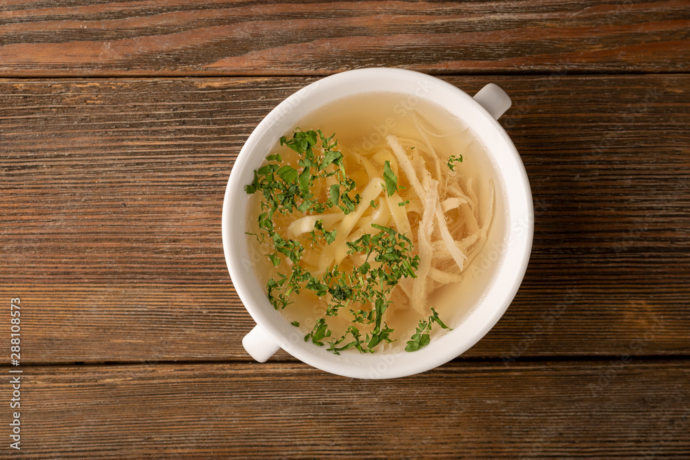 Stock with noodles and white meat on wooden Stock with noodles and white meat on wooden