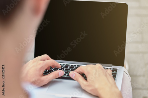 Young man using his laptop in the park