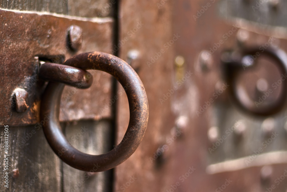 Rusty ring on a vintage wooden door