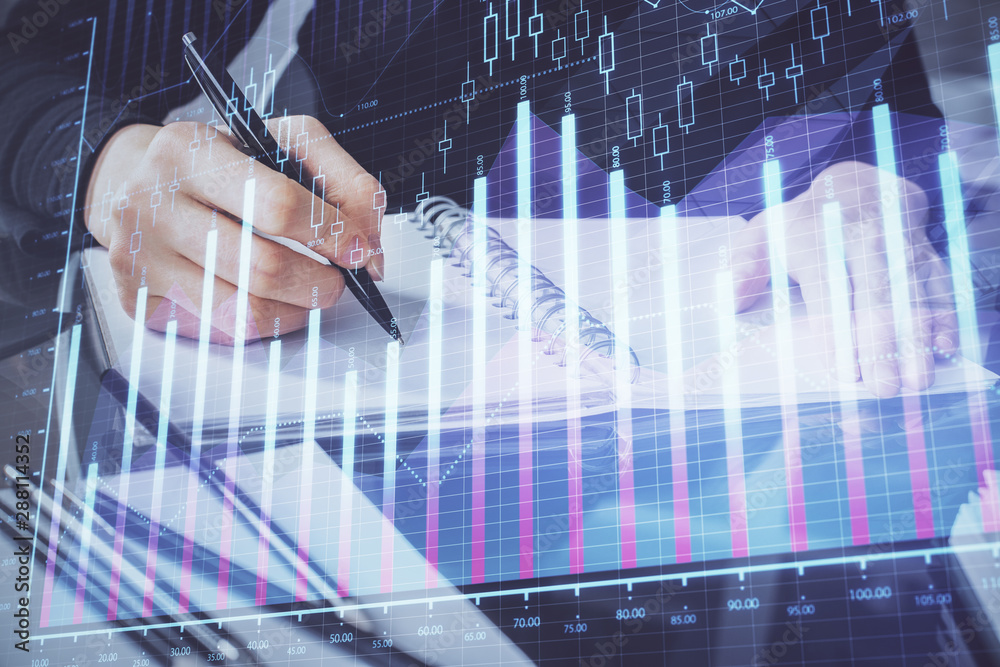 Forex chart hologram on hand taking notes background. Concept of analysis. Multi exposure Forex chart hologram on hand taking notes background. Concept of analysis. Multi exposure