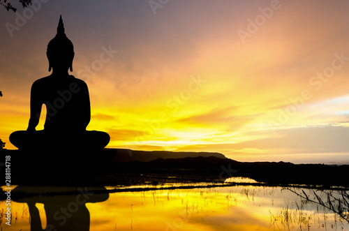 Photography Silhouette largest statue Buddha image in the sunset over the hill, Water reflec