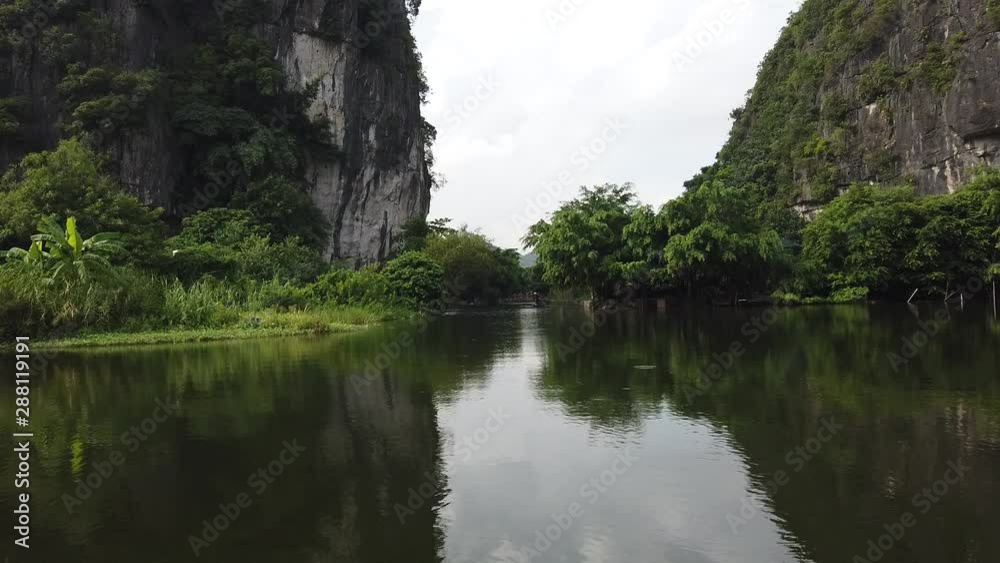Exploring Tam Coc limestone mountains on a rowing boat, wonderful landscape and nature on a UNESCO World Heritage site in north Vietnam Exploring Tam Coc limestone mountains on a rowing boat, wonderful landscape and nature on a UNESCO World Heritage site in north Vietnam