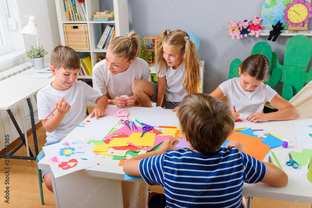Fototapeta premium Preschool Teacher with Children at Kindergarten - Creative Art Class