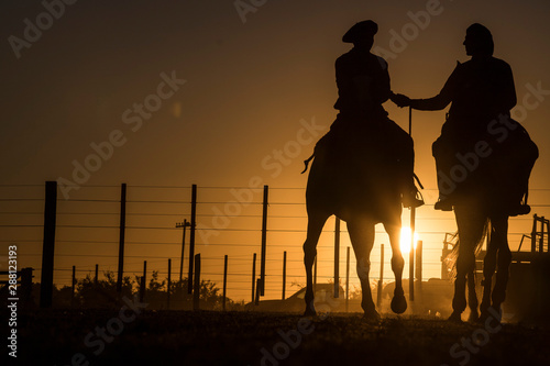 Gauchos / Cowboys  im Abendlicht photo