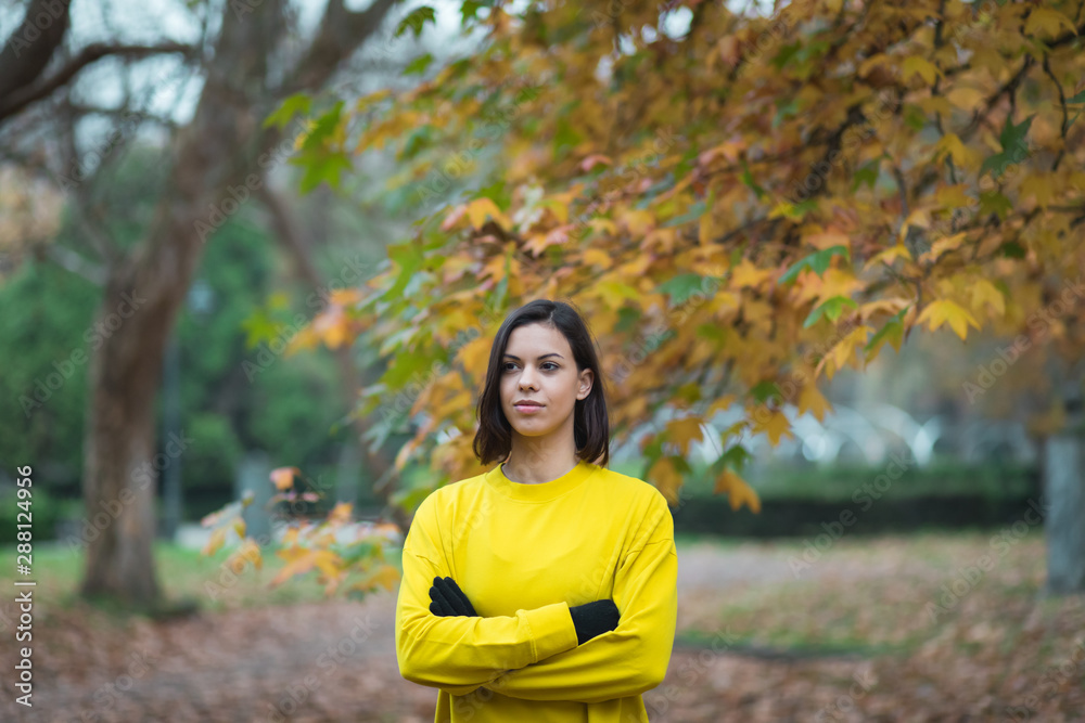Portrait of confident sporty woman on autumn at city park. Fall season outdoor fitness workout. Portrait of confident sporty woman on autumn at city park. Fall season outdoor fitness workout.