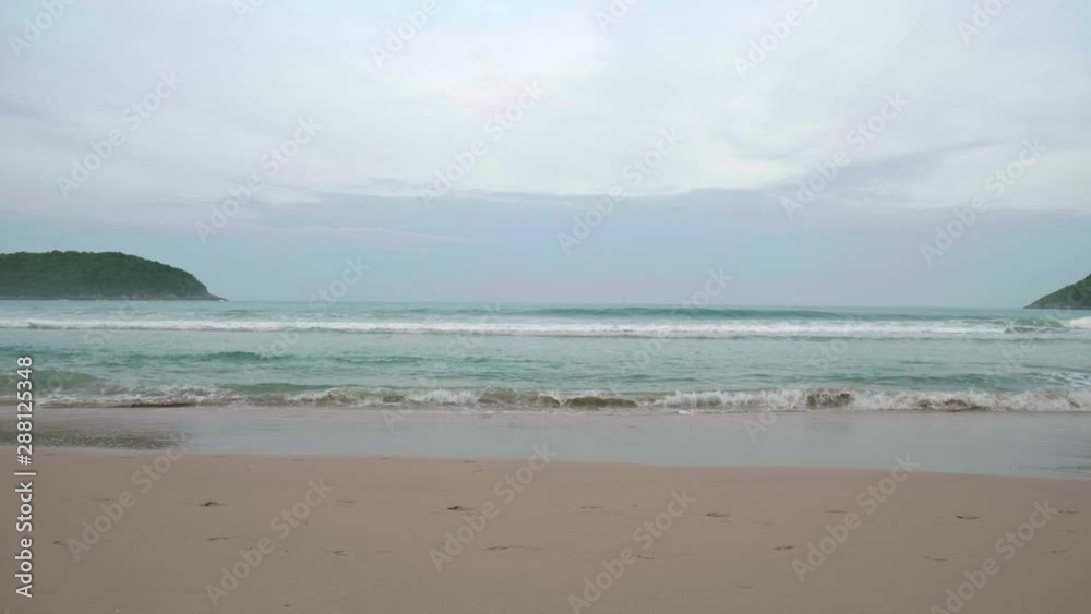 Ocean waves breaking into the shore on the beach in Phuket, Thailand. Ocean waves breaking into the shore on the beach in Phuket, Thailand.