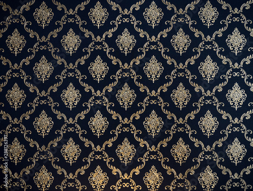 golden line thai pattern on navy blue fabric for background