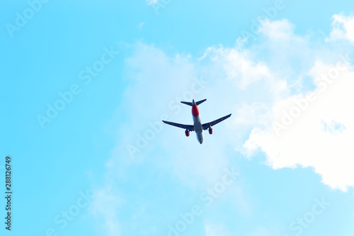 passenger plane flying in the blue sky bottom view  flight  aviation  tickets