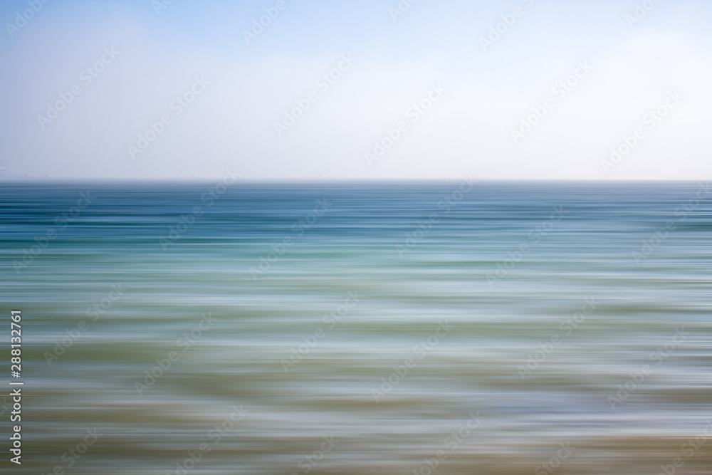 An abstract seascape with blurred panning motion with mussel rafts at the back